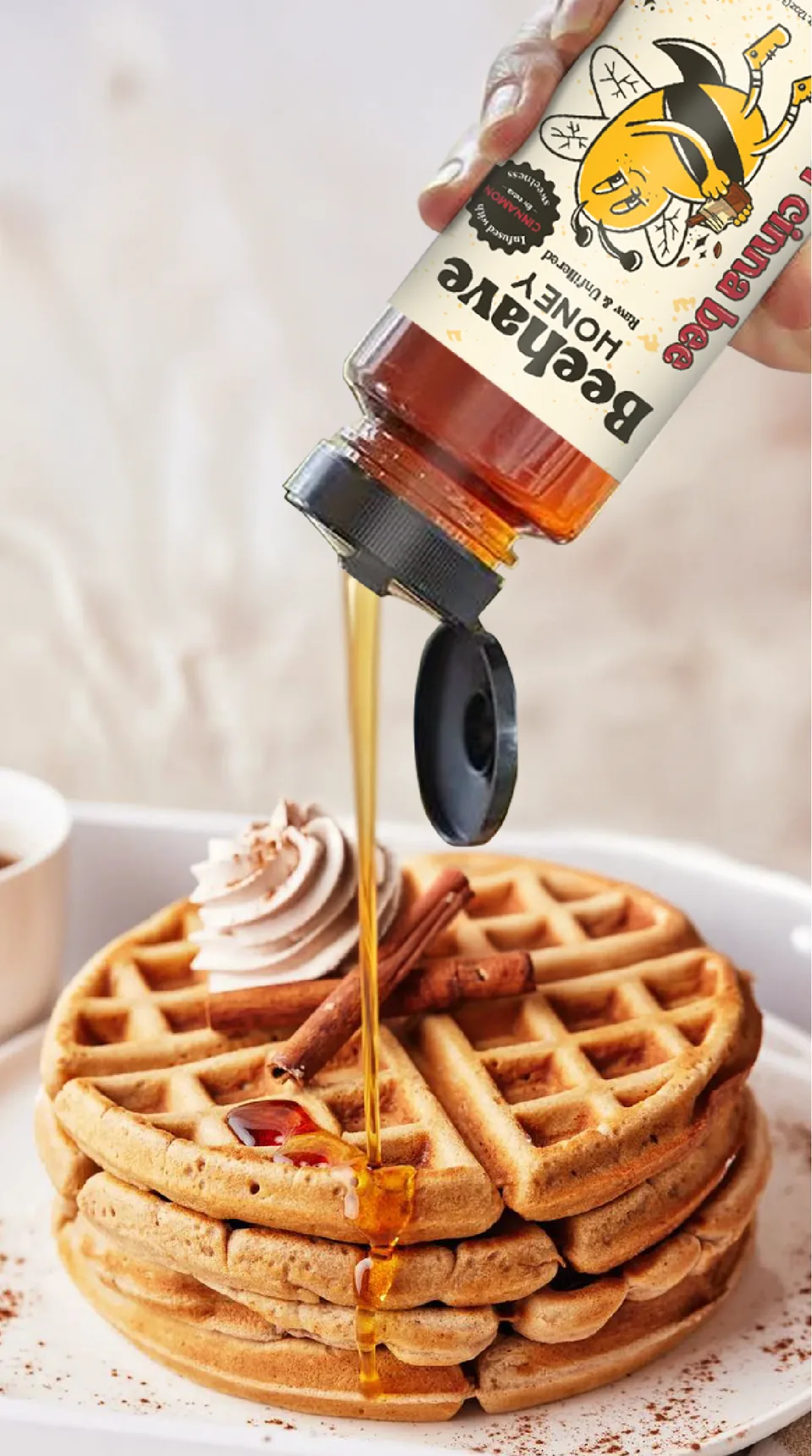 Sweet Cinna Bee honey pouring over a stack of waffles